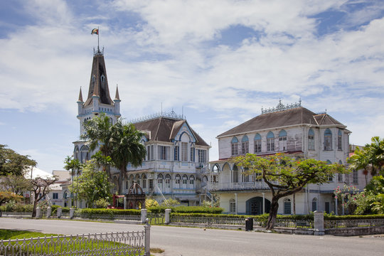 View of an old wooden fairy-tale Gothic building with spires and turrets on a clear Sunny day, the city hall of Georgetown, Guyana. World tourism, architecture.