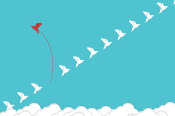 Think differently concept. Be different. Red bird changing direction. New idea, change, trend, courage, creative solution, innovation and unique way concept.	
