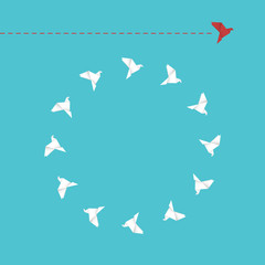 Think differently concept. Be different. Red bird changing direction. New idea, change, trend, courage, creative solution, innovation and unique way concept.	