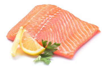 Salmon steak with lemon on white background