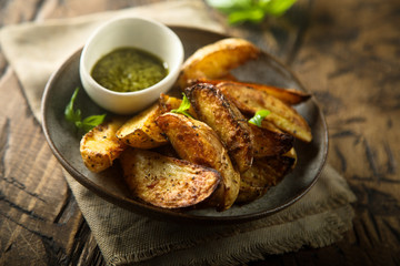 Roasted potato wedges with homemade pesto sauce