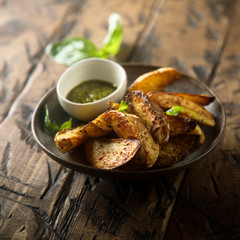Roasted potato wedges with homemade pesto sauce