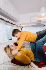 Family mother and son play in trailer. Mother's day greeting card