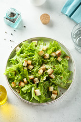 Homemade Caesar salad on a white plate