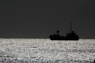 Ship silhouette and night sea