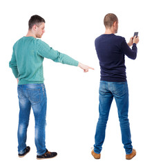 Back view of two man in sweater with mobile phone.