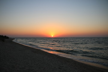 pink sunset by the sea in summer on vacation, beautiful sky unusual