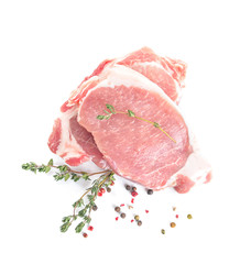 Raw pork meat with spices and herbs on white background