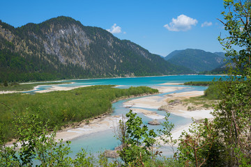 isar river flows into lake Sylvenstein, bavarian landscape. blue sky with copy space