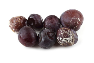 Rotten plums isolated on white