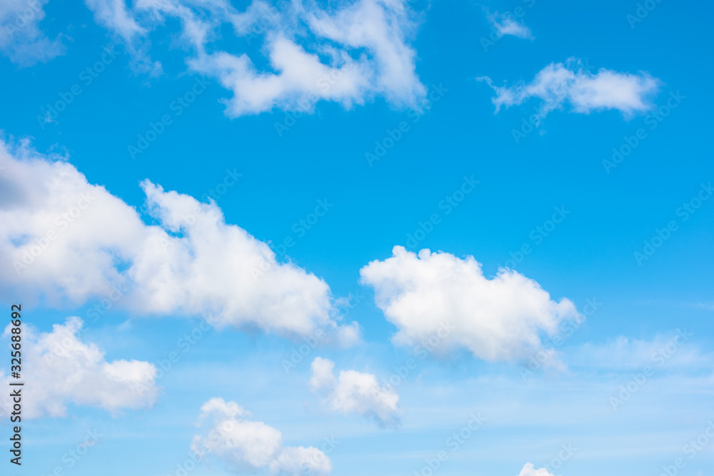 Wall mural gorgeous cloudscape in springtime. weather background with dynamic cloud arrangement on a blue sky. 
