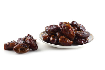 Date fruits on saucer isolated on white