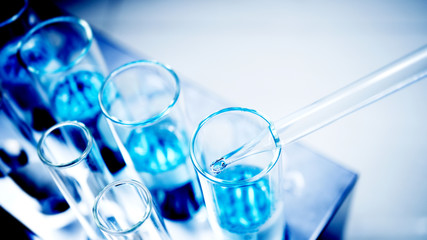 drop blue liquid and droplet laboratory for science test , lab chemical study and medical concept background - 325689472