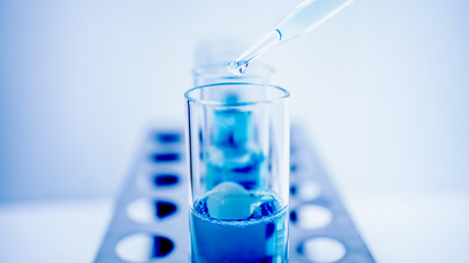 drop blue liquid and droplet laboratory for science test , lab chemical study and medical concept background