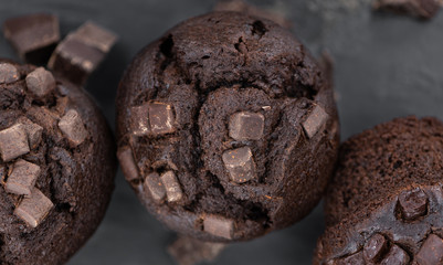 Some Chocolate Muffins (close-up shot; selective focus)