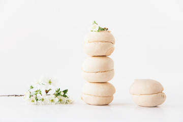 The marshmallows and flowers on the white background.Minimalism.Space for text.Mock up