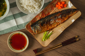 Japan food, Grilled saba or mackerel with sweet sauce served with miso soup and cooked rice placed on wooden table