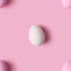 Seamless pattern of Easter eggs over pink background, top view