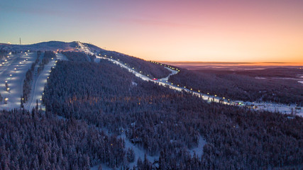The ski slopes of Levi ski resort at sunrise, Kittilä, Finland. A wintery landscape in Finnish Lapland. 