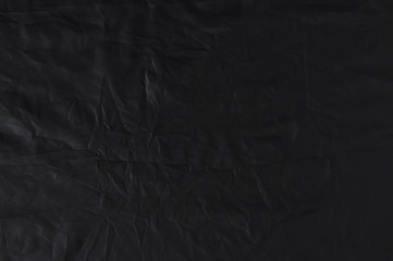 Crumpled black fabric cloth texture.  Abstract elegant textured textile background for design....