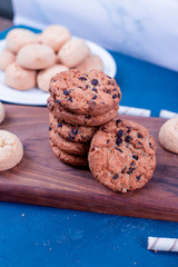 Chocolate cookies and biscuits on the cutting board. top view