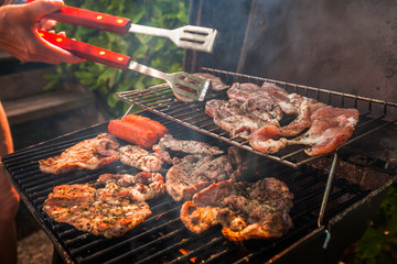 Grilling meat outdoors during a weekend rest