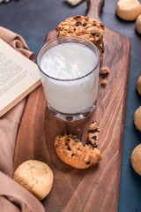 A glass of milk with sweet cookies