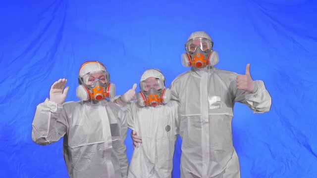 The family shield protect, to save life from virus. Slow motion. People portrait, wearing protect medical aerosol spray paint mask respirator. Concept health safety protection coronavirus epidemic.