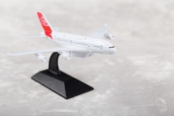Small airplane toy on grey background