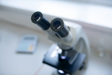 Close up picture of a microscope on the table