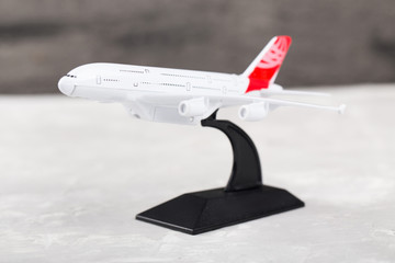 Small airplane toy on grey background