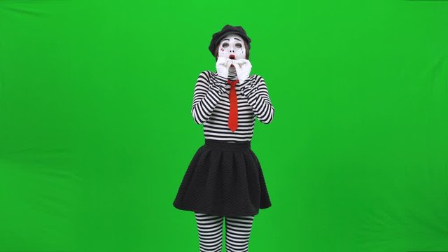 Mime girl is inflating a balloon. Green screen, Chroma key.