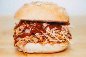 hands holding Pulled Pork Hamburger bbq and beer