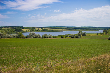 Panoramic view on blue lake and green meadow near Ukrainian village of Bovtyshka, Kirovograd...