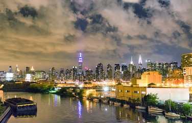 Fototapeta premium Night view of Midtown Manhattan panoramic skyline with East River, New York City