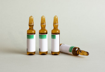 isolated ampoules of magnesium metamizole on grey background.