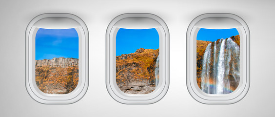 Airplane windows with Iceland waterfalls view. Travel and holiday abstract concept