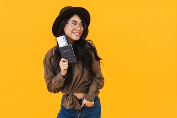 Fototapeta na wymiar Cheerful young asian woman showing passport
