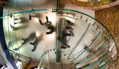 Underneath view of people feet walking on a circular staircase