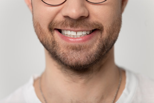 Close up cropped image wide toothy smiling young bearded man.