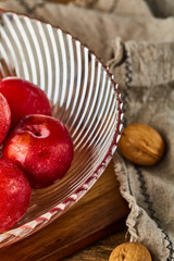 Red plums in a glass fruit plate