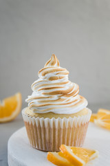 Lemon meringue cupcake. Homemade fresh pastries, delicious food. Close-up, copy space, gray background.