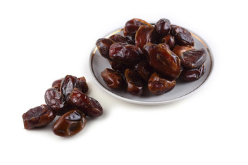 Date fruits on saucer isolated on white