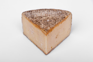 french cow's milk cheese called Tomme de Savoie isolated on white background