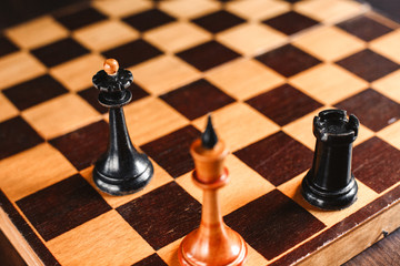 Checkmate. Chess pieces: King surrounded by Queen and Rook