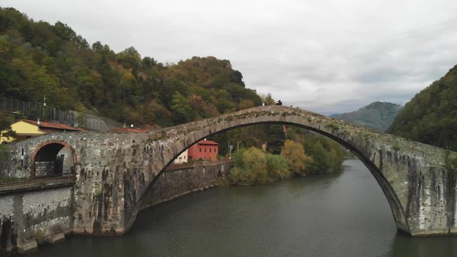Aerial overhead view of Devils Bridge-Ponte della Maddalena is a bridge crossing the Serchio river near the town of Lucca