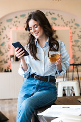 Attractive young brunette woman studying in the cafe indoors