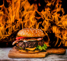 Tasty smoked grilled and glazed beef burger with lettuce, cheese and bacon served with french fries...