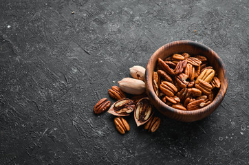 Pecan nut in a bowl. Healthy Eating. Top view. Free space for your text.