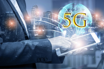 Double exposure of businessman using tablet with growing globe animation model with 5G and connection line. Business for new mobile internet services are already on offer to connection